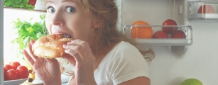 women binge eating in fridge