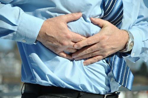 Pain Management Hypnotherapy, man holding painful stomach