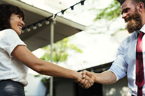 Increasing Assertiveness Hypnotherapy, man & woman shaking hands in agreement