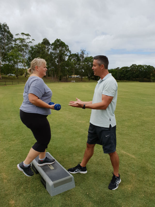 Personal trainer in park with client